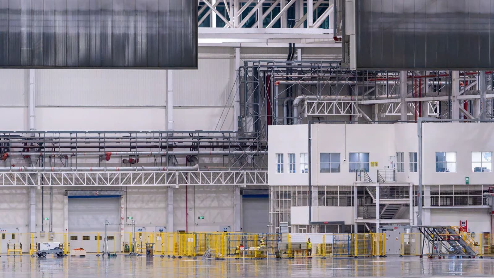 Industrial facility production line with overhead cable containment