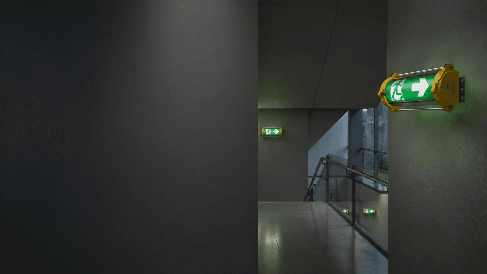 Professional building corridor with illuminated emergency exit guidance and emergency lighting
