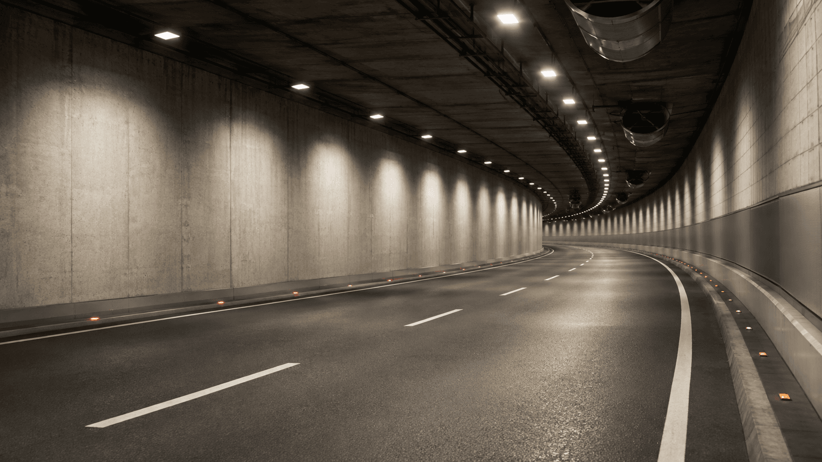Floodlit night-time tunnel and heavy-industry infrastructure scene