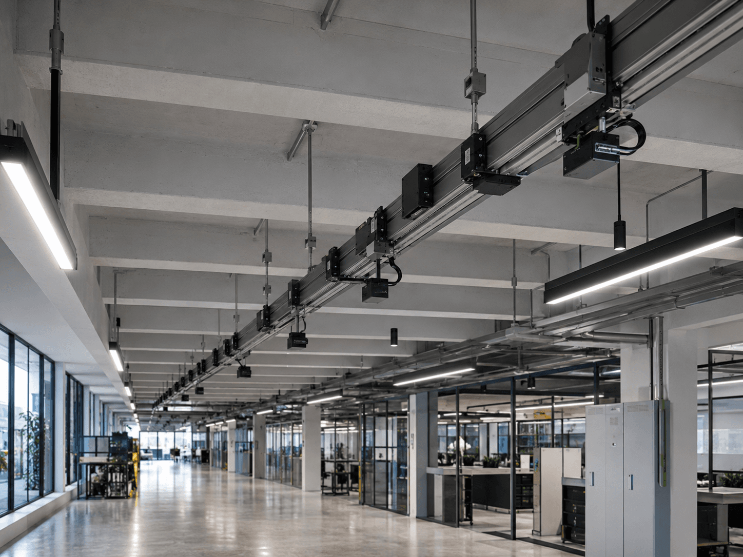 Industrial ceiling busbar power distribution track with integrated linear LED lighting